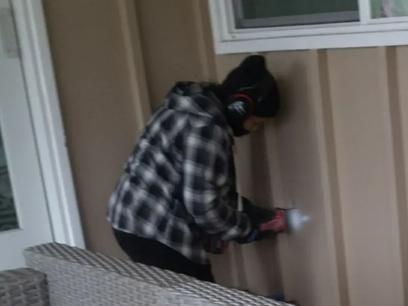 Professional electrician installing an exterior outlet in Frisco